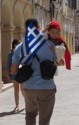 Dad holds a little boy with a Greek flag